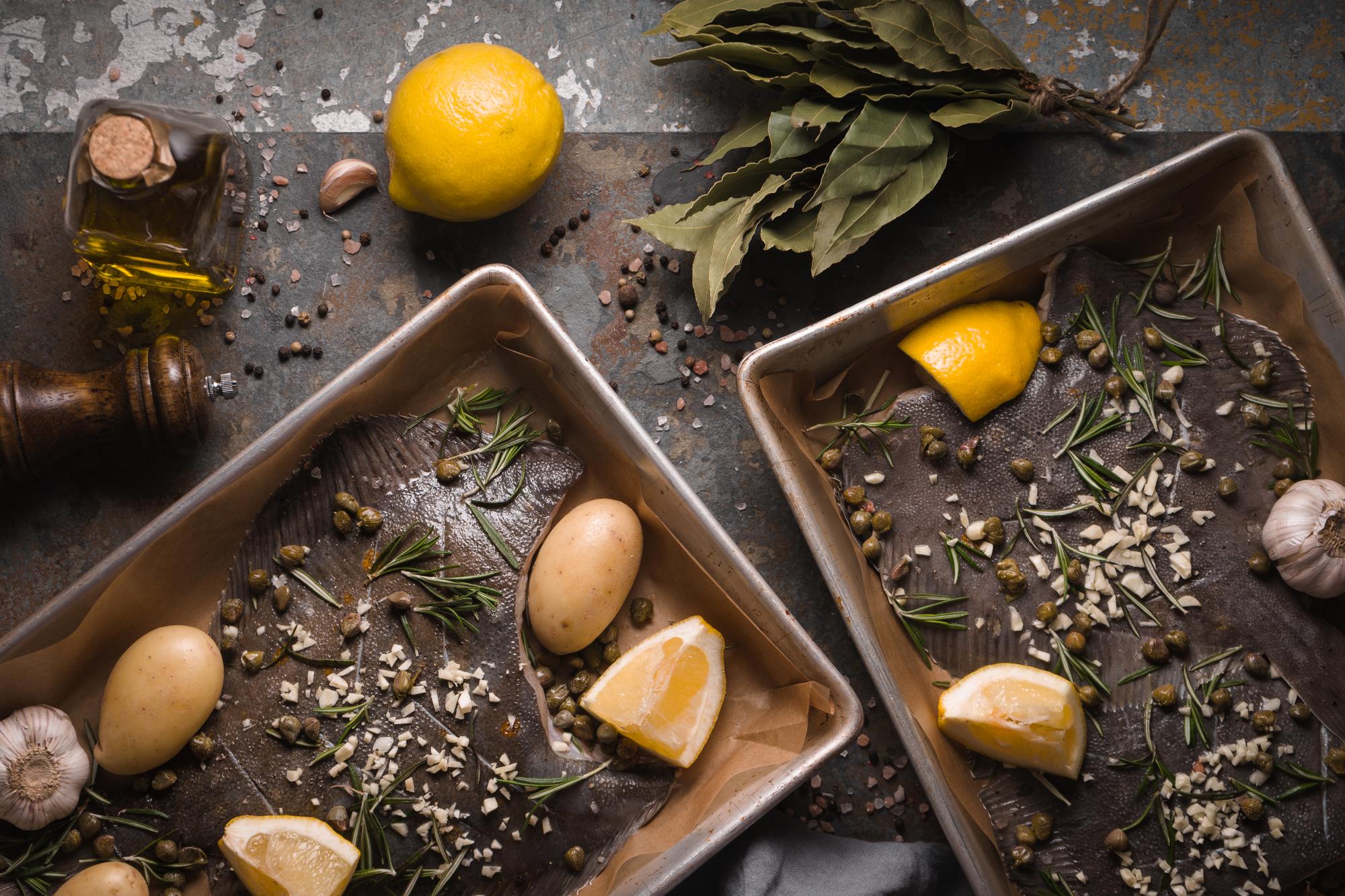 Close-up of seasonal ingredients on a bench: herbs, citrus, spices