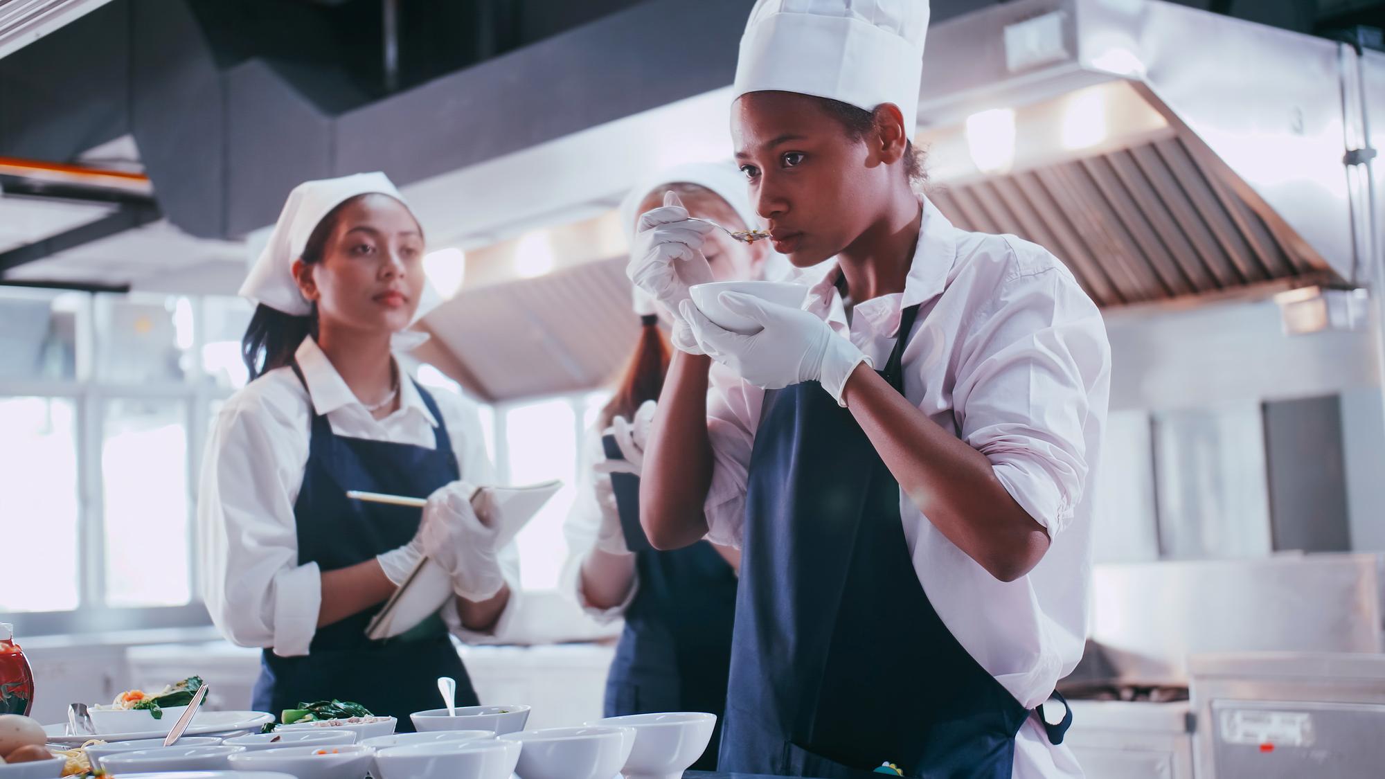 Chef and team in a modern kitchen preparing service